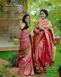 two women standing next to each other in sari