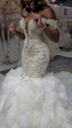 a woman in a wedding dress is posing for the camera