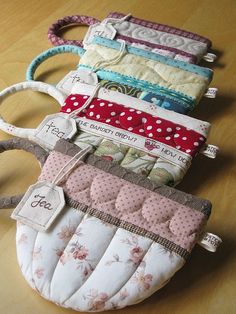 several small purses sitting on top of a wooden table