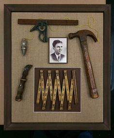 an old framed photo with some tools and a man's name on it,