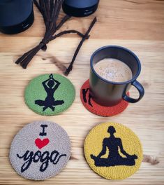 three coasters with yoga designs on them and a cup of coffee in the middle