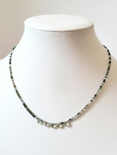 * This necklace is made entirely of natural stones of 2mm round green agate and faceted drop of transparent light green prasiolite. *All findings are 14k gold plated * The necklace measures 44cm * Handmade item * Free delivery by post by registered letter * Necklace for women * Delivered in its reusable cotton protective pouch * Instagram _atelier768_ * Semi-precious stone necklace * Unique piece Green Moss Agate Round Bead Necklaces, Green Moss Agate Round Bead Necklace, Green Faceted Briolette Necklaces, Green Faceted Briolette Necklace, Green Briolette Necklace With Natural Stones, Green Briolette Faceted Necklace, Necklace Unique, Green Agate, Letter Necklace