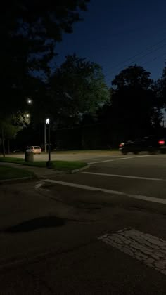 an empty parking lot at night with the lights on