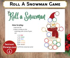 the roll a snowman game is shown on a wooden table with christmas decorations and ornaments