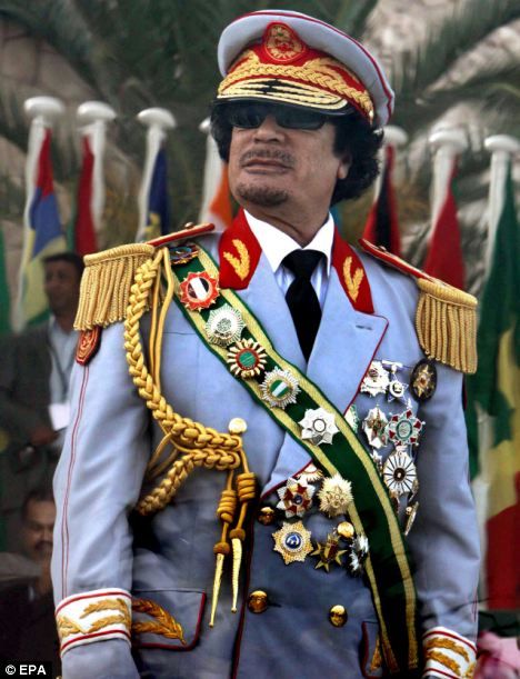 Heavily decorated: Gaddafi pictured in an ostentatious military uniform in 2009, watching a parade to mark the 40th Anniversary of the Libyan Revolution African Dictators, Ventriloquist Doll, African Kings, Muammar Gaddafi, The Dictator, African Royalty, Shocking News, African History, Military Uniforms