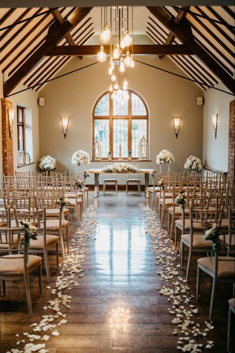 Beautiful aisle decor - white rose petals line the aisle with rose and gypsophilia bunches tied to the chairs - large displays either side of ceremony table with a long low display - nuthurst grange wedding venue - penny johnson flowers coleshill