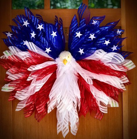 New PATRIOTIC EAGLE WREATH! I watched and learned from Monkey’s Creations the basics for this wreath design. I did tweak it a tad though. I began with the UITC Wing board and used foiled edged mesh in Red, White & Blue. The EAGLE HEAD was purchased on Etsy. I added white feathers to the neck. Eagle Wreath Diy, Wing Board, Eagle Wreath, Christmas Ribbon Crafts, Mesh Ribbon Wreaths, Patriotic Eagle, Eagle Wings, Mesh Ribbon, Ribbon Wreath