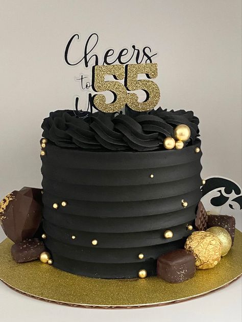 Black buttercream cake decorated with gold balls, chocolates and a cake truffle heart Black Buttercream Cake For Men, Black Gold Cake Men, Black And Gold Buttercream Cake, Black And Gold 50th Birthday Cake, Black And Gold Birthday Cake For Him, Black Gold Cake Birthday, Black Gold And White Cake, Black Cake For Men, Black And Gold Cake Birthday For Women