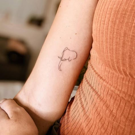 Minimalist line art elephant tattoo on the inner arm. Best Elephant Tattoo, Elephant Tattoo Line Art, Simple Line Art Tattoos For Women, Minimalist Elephant Tattoo Simple, Tattoo Of Elephant, Elephant Micro Tattoo, Elephant Tattoo Placement, Elephant Tattoo Placement Ideas, Elephant And Sun Tattoo