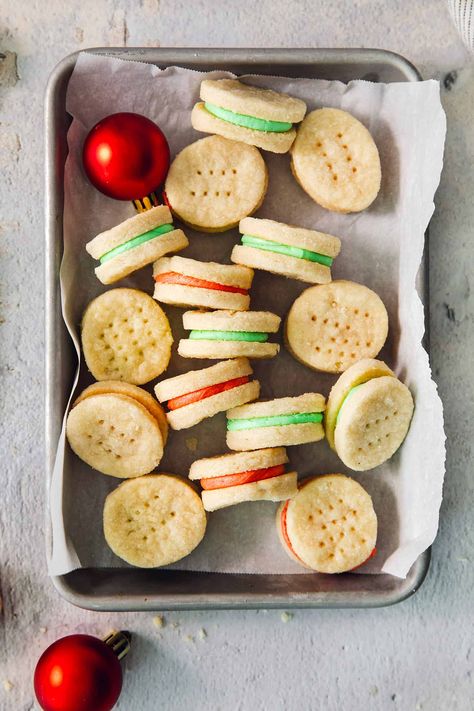 Buttery Cream Wafer Cookies are a beautiful addition to any holiday cookie box! Tender cookie rounds sandwich a sweet, festively colored buttercream filling to make the perfect seasonal treat. Vanilla Wafer Sandwich Cookies, Cookie Sandwich Recipes Buttercream Frosting, Buttercream Filled Cookies, Creme Filled Cookies, Cream Wafer Sandwich Cookies, Vanilla Wafer Christmas Cookies, Cream Cheese Sandwich Cookies, Buttercream Sandwich Cookies, Frosting Filled Cookies