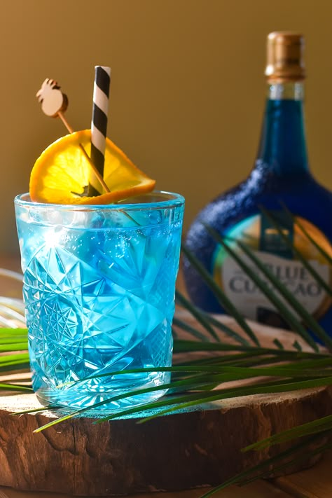 The Blue Gin Delight is a cocktail made of Blue Curacao and Gin with a well-balanced taste. #cocktail #recipe #gin #bluecuracao #cocktailrecipe Gin And Blue Curacao, Blue Gin Cocktail Recipes, Blue Gin And Tonic, Blue Gin Cocktail, Gin Blue Curacao, Blue Gin Drinks, Blue Curacao Cocktails, Brandy Liquor, Blue Gin