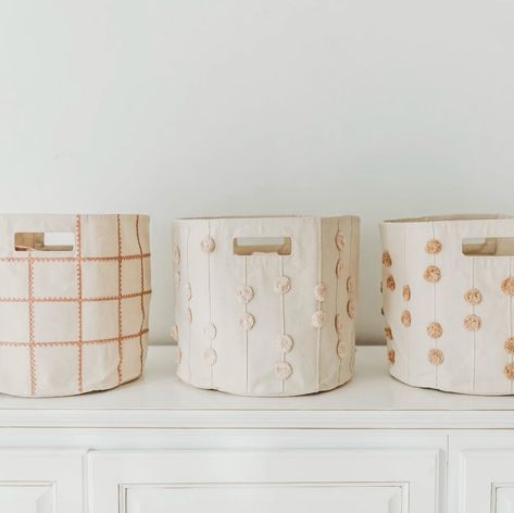 Our infamous storage bins are the perfect way to keep toys and books organized in any part of your home! They are made to be durable for holding all of your little one’s prized possessions with collapsible fabric and handles for easy movement. They currently come in 2 different styles: Lace and PomPom, both featuring a variety of color options! 🧸 Are you team Lace or PomPom? #kidsstoragebasket #storagebasket #toddlerstoragebasket #babybasket #babybrand #toddlerclothes #organiccottonclothi... Baby Nursery Laundry Basket, Nursery Organization Baskets, Print Shop Ideas, Kids Storage Baskets, Kids Storage Bins, Linen Closet Storage, Portable Changing Pad, Mini Crib Sheets, Toddler Pillow