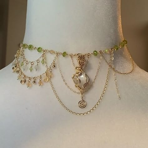 Victoria on Instagram: "✨Hey everyone!! Just checking in while I’m finishing up a special collection to send to @ariisacat for my FIRST EVER fairy choker photoshoot(!!!!)🥹❤️‍🔥 This is a work in progress shot of a peridot, white moonstone, and Ethiopian opal on 14k gold filled Tinkerbell inspired choker (thank you to @kailifornia_ for inspiring me to do this when I posted these peridot beads a couple months ago!!) I wanted my first fairy choker photoshoot to feature pieces that resonate the most with the creative vision that drives the Soul Society. Working on these pieces with these sweet pastel color palettes has without question been keeping my mind in a state of never ending spring!! I keep walking outside and thinking “omg what a beautiful spring day”…🫠So I decided it would be fitti Elven Jewelry Necklaces, Jewellery Layout, Fairy Choker, Diy Jewelry Videos, Elf Jewelry, Ethereal Jewelry, Elf Dress, Soul Society, Pumpkin Candle