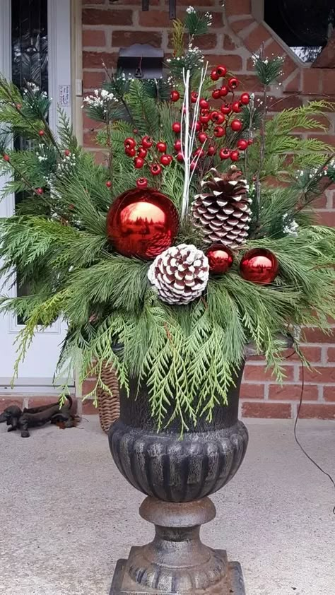 90+ Easy DIY Outdoor Christmas Decorations - Holidappy Outdoor Christmas Urns Planters, Front Door Christmas Planters, Holiday Porch Pots, Christmas Pots Outside Front Porches, Large Ornaments Outside, Christmas Urns Front Porch, Outdoor Christmas Planter Ideas, Christmas Porch Pots, Christmas Planters Diy