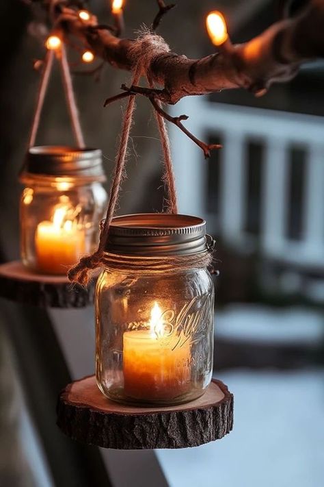 Mason Jar Lanterns1 Mason jar candles hanging from rustic tree branch with twine, creating a cozy and warm outdoor ambiance with soft lighting. | Sky Rye Design Mason Jar Lanterns Wedding, Diy Fall Lanterns, Diy Hanging Candles, Diy Lanterns Outdoor, Mason Jar Lanterns Diy, Jar Lights Diy, Outdoor Boho Decor, Diy Mason Jar Lanterns, Candle Latern