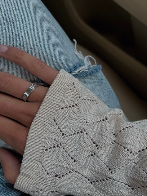 A picture of a hand with a crochet patterned long sleeve sweater and a silver Cartier love ring on. Beautiful tan skin and denim jeans Silver Love Ring Cartier, Cartier Rings Aesthetic, Cartier Love Ring Aesthetic, Cartier Love Ring Silver, Cartier Ring Aesthetic, Silver Cartier Ring, Blue Summer Aesthetic, Cartier Aesthetic, Chic Style Women