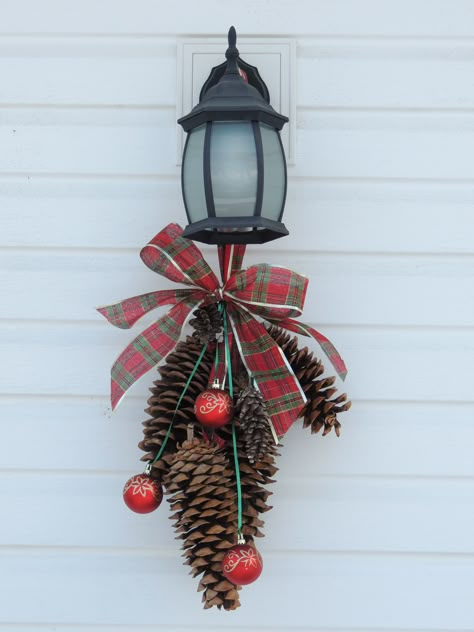 add a swag on our back porch light during the holidays Outdoor Xmas Decor, Christmas Coming Soon, Outdoor Holiday Planters, Front Porch Light, Christmas Lamp Post, Christmas Flower Decorations, Holiday Decor Diy, Outside Lights, Holiday Planter