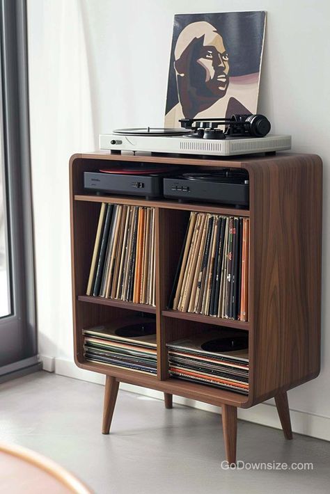 This wooden feature follows a common midcentury design shape and remains standard with a straightforward layout. Home Turntable Setup, Vinyl Record Nook, Mid Century Modern Vinyl Record Storage, Audio Racks And Stands, Hifi Cabinet Ideas, Record Player Corner, Vinyl Player Setup, Turntable Decor, Lp Regal