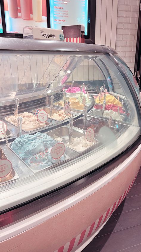 Pastel ice cream parlour with many flavours of ice cream in a glass case Ice Cream Maker Aesthetic, Japan Ice Cream Shop, Ice Cream Parlour Aesthetic, Old Fashion Ice Cream Shop, Cute Shop Aesthetic, Pink Ice Cream Aesthetic, Japanese Ice Cream Shop, Beach Ice Cream Shop, Ice Cream Store Aesthetic