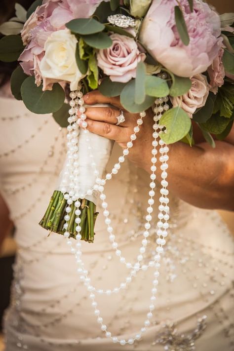 Bride holding big unique bouquet with strings of pearls hanging from underneath String Of Pearls With Wedding Dress, Wedding Bouquets With Pearls, Wedding Bouquet With Pearls, Bridal Bouquet With Pearls, Bouquet With Pearls, Pearls In Bridal Bouquet, Pearl Bouquet Wedding Diy, Pearl Bridesmaid Bouquet, Pearls In Bouquet