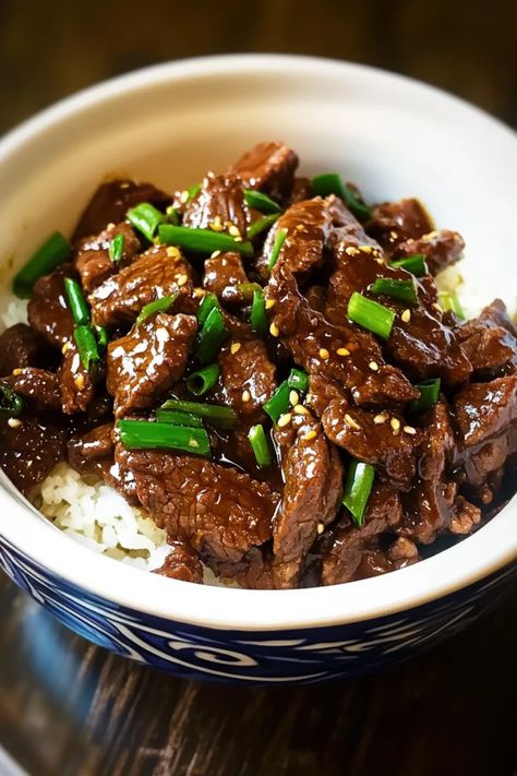 This slow cooker Mongolian beef is packed with bold flavors! Tender beef simmers in a rich, sweet, and savory sauce with a hint of garlic and ginger. It’s a delicious takeout favorite made easy at home, perfect for serving over rice or noodles. Ready to cook? Click for the recipe #slowcookerrecipes #mongolianbeef #beefrecipes #asianfood #easymeals #takeoutathome #comfortfood #weeknightdinner #slowcooked Mongolian Beef Slowcooker, Crockpot Mongolian Beef Recipe, Best Mongolian Beef Recipe, Asian Roast, Crockpot Mongolian Beef, Slow Cooker Mongolian Beef, Chinese Beef Recipes, Mongolian Beef Recipe, Ginger Beef