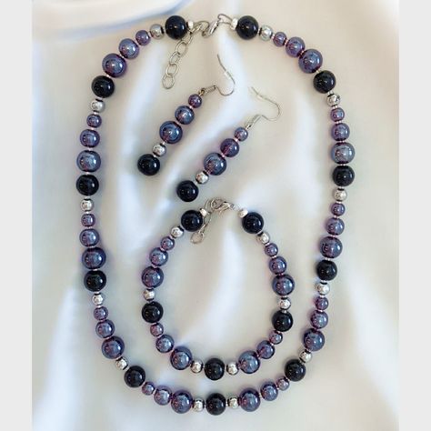 Purple & Black Beaded Necklace Set Set includes necklace, bracelet, and earrings Made with translucent purple & solid black round glass beads, silver coloured metal spacer beads, and lobster claw clasps Earrings made with nickel free ear wire Black Beaded Necklace, Red Sunglasses, Black Bead Necklace, Glass Necklace, Glass Jewelry, Black Glass, Ear Wire, Purple Black, Black Beads