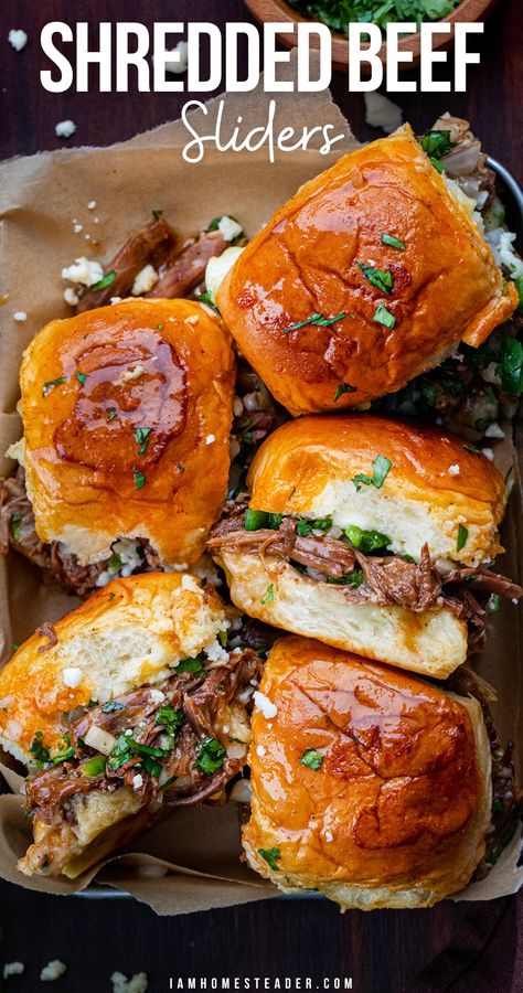 Sliders in a parchment lined tray, some turned on their side. Flank Steak Shredded Beef, Bbq Shredded Beef Sandwiches, Crockpot Shredded Meat Recipes, Crockpot Beef Sliders Recipes, Hot Beef Sandwich Recipes, Chopped Beef Sliders, Shredded Beef Baked Potato, Beef Pulled Sandwiches, Beef Brunch Ideas