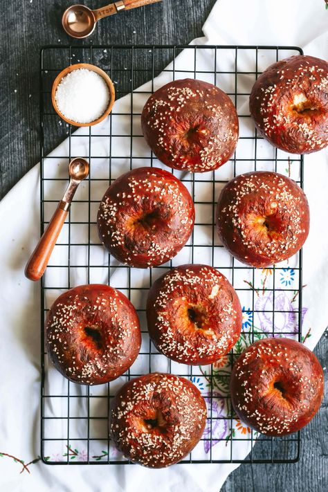 an overhead shot of 8 pretzel bagels on a black wire cooling rack Pretzel Bagels, Pretzel Bagel, Bread Starter Recipe, Bagel Ideas, Types Of Bagels, The Practical Kitchen, Pita Crackers, Bagel Recipes, Pretzel Dough