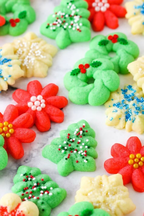 These Spritz Cookies are buttery, tender and such festive Christmas cookies! The cookie dough is super easy to put together and there's so many ways to decorate them. A great make-ahead cookie! Christmas Cookie Easy, Best Spritz Cookie Recipe, December Baking, Buttery Spritz Cookies, Cabin Meals, Christmas Spritz Cookies, Festive Christmas Cookies, Spritz Cookie, Best Gingerbread Cookies