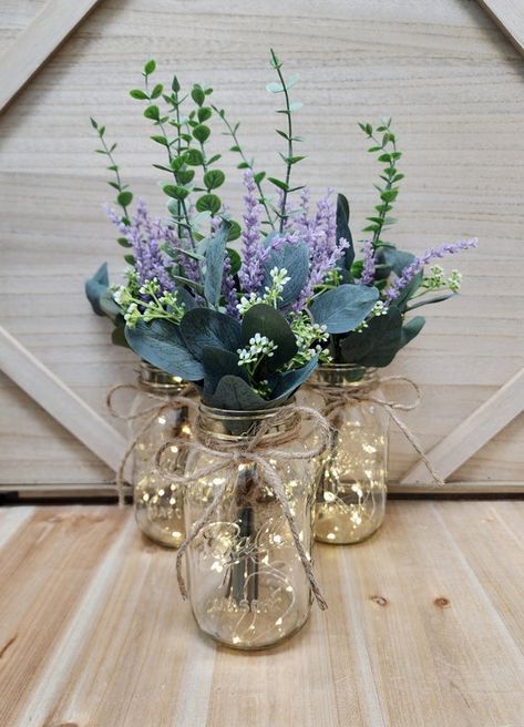 lavender eucalyptus wedding - Google Search Lavender And Bronze Wedding, Lavender In Mason Jars, Lilac Eucalyptus Wedding, Lilac Mason Jar Centerpieces, Lavender Center Piece Wedding, Sage Green And Purple Wedding Centerpieces, Sage And Lavender Centerpieces, Navy And Lilac Wedding Decor, Cottagecore Wedding Table Decor