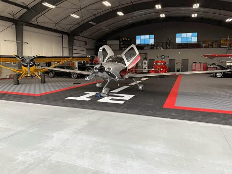 Ribtrax is the perfect complimentary flooring in this hangar. Taking this space to a new level. #Hangar #Aircraft #HangarFlooring #Swisstrax #Ribtrax #Cirrus Airplane Hangar Man Cave, Airplane Hanger House Plans, Aircraft Hanger House, Hangar Homes Floor Plans, Hangar Decor, Airplane Hangar Design, Private Hangar, Plane Hanger, Hangar Architecture