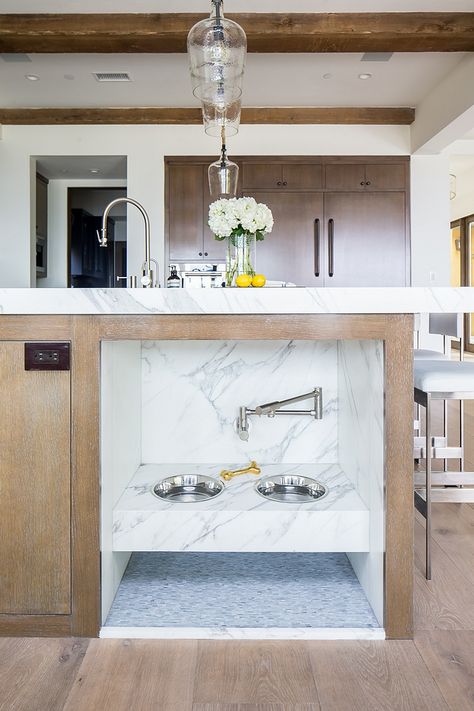 Kitchen Island with Pet Feeding Station This kitchen island features a custom dog feeding station that comes even with a swing arm faucet (pot filler) to easily refill the water bowls #KitchenIsland #PetFeedingStation #dogfeedingstation #potfiller Beach House Decor Kitchen, Beach House Tour, California Beach House, Dog Feeding Station, Modern Remodel, Home Bunch, Dog Rooms, Dining Room Inspiration, California Homes