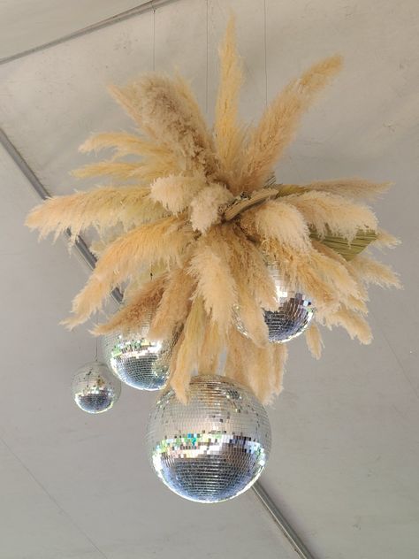 Pampas grass and disco balls combined to make the perfect centerpiece in this tent top for the boho glam wedding. Pampas Grass Disco Ball, Pampas And Disco Ball Wedding, Rustic Glam Decor Wedding, Pampas Disco Ball, Pampas Chandelier, Boho Disco Party, Rustic Glam Decor, Country Prom, Grass Centerpiece