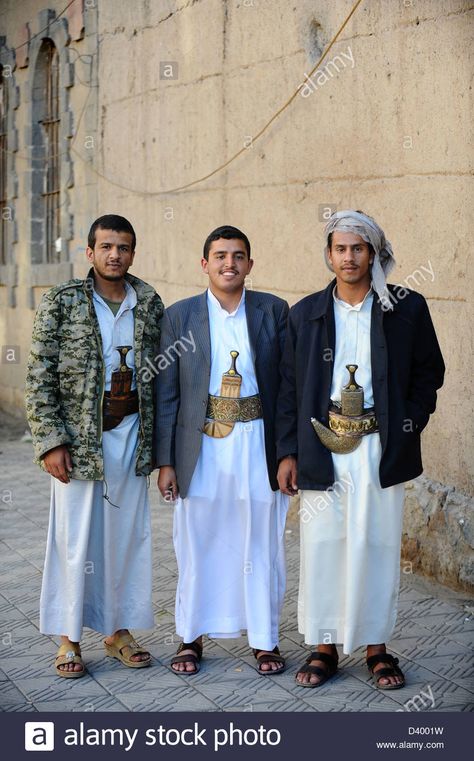 Three Yemani men on the streets of Sana'a, capital City of Yemen. Wearing traditional dress with traditional knife, the Jambiyya Stock Photo Australian Grand Prix, Western Asia, Man Clothes, Outfit Png, Muslim Men, Embroidered Belt, Muslim Dress, Men Street, Yemen