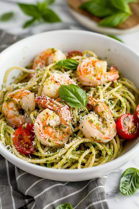 This pesto shrimp pasta features succulent shrimp, salty Parmesan, and bright cherry tomatoes in a garlicky pesto sauce with plenty of tender noodles. Shrimp Tomato Pasta, Pesto Shrimp Pasta, Shrimp Pesto Pasta, Healthy Pesto, Pesto Shrimp, Pesto Pasta Recipes, Eating Well Recipes, Shrimp Scallops, Prawn Recipes