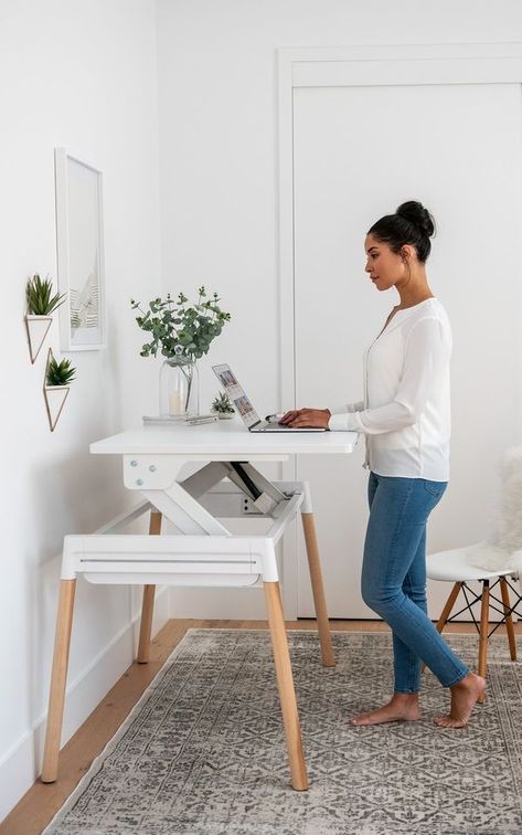 Inscape, a local office furniture supplier with a sleek showroom at Bay and Wellington, recently updated one of their popular office desks for the home. The Scandinavian-inspired design—available in a white or walnut surface with pale wood or metal legs—is unassuming when it’s lowered but lifts easily up and slightly forward to ergonomically complement a good standing position. Small Adjustable Standing Desk, Home Office 2 Monitors Computer Desks, Mcm Adjustable Desk, Home Office Eames Chair, Sit To Stand Desk Home Office, Sitting And Standing Desk, Sit And Stand Desk Home Office, Home Office For Small Spaces Bedroom, Adjustable Standing Desk Home Office