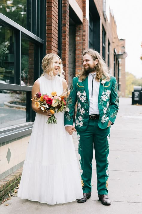 Jimmy + Meghan's Country Music inspired wedding ensembles featured a custom nudie suit and custom embroidered white denim jackets. | Image by Sarah Murray Photography #creativeweddingideas #eclecticweddingideas #greenweddingtuxedo Non Traditional Wedding Tuxedos, Embroidered Wedding Suit Men, Mens Alternative Wedding Attire, 70s Groom Suit, Embroidered Wedding Suit, Unique Wedding Suits, Unique Groomsmen Attire, Country Groom Attire, Wedding Powerpoint