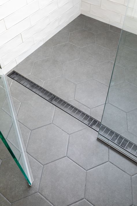 Continuous Bathroom Shower Floor, Tiled Bathroom Floors And Showers, Small Grey Hexagon Tile Bathroom, Seamless Bathroom Shower Floor, Walk In Shower With Hexagon Tile, Big Tile In Shower Floor, Large Tile For Shower Floor, Light Gray Hexagon Tile Bathroom, Large Gray Hexagon Tile Bathroom