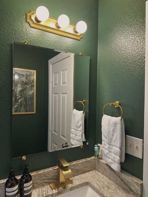 Dark green walls, with gold hardware Emerald Gold Bathroom, Dark Green And Gold Decor, Dark Green And Gold Bathroom Ideas, Black And Green Apartment Aesthetic, Green Black And Gold Bathroom, Dark Green And Gold Bathroom, Emerald Green And Gold Bathroom, Gold And Green Bathroom, Dark Green Bathroom Walls