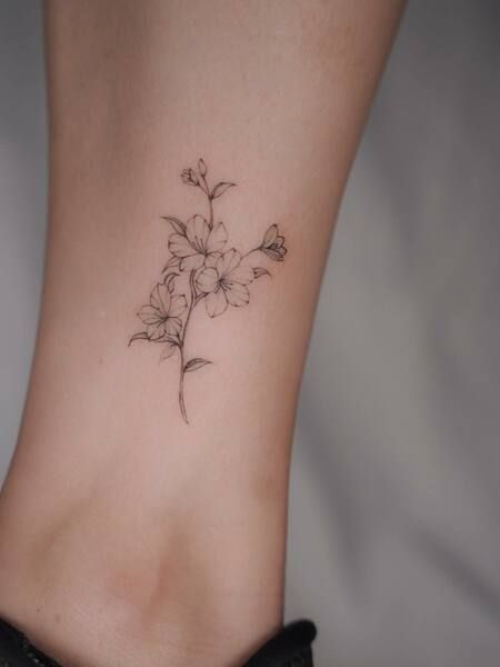 Simple Cherry Blossom Tattoo Azaleas Flower Tattoo, Tulip And Cherry Blossom Tattoo, Line Work Cherry Blossom Tattoo, Minimalist Tattoo Cherry Blossom, Dainty Flower Ankle Tattoo, Breathe Flower Stem Tattoo, Small Japanese Cherry Blossom Tattoo, Fine Line Azalea Tattoo, Cherry Bollsom Tattoo