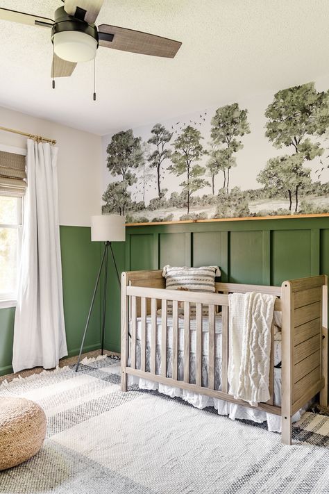 A baby boy nursery gets a woodland themed makeover with deep green, cozy lighting, and peel & stick watercolor style wall mural on a budget. Green And Grey Nursery, Nursery Makeover, Green Painted Walls, Cozy Lighting, Board And Batten Wall, Nursery Room Design, Green Nursery, Baby Room Inspiration, Baby Boy Room Nursery