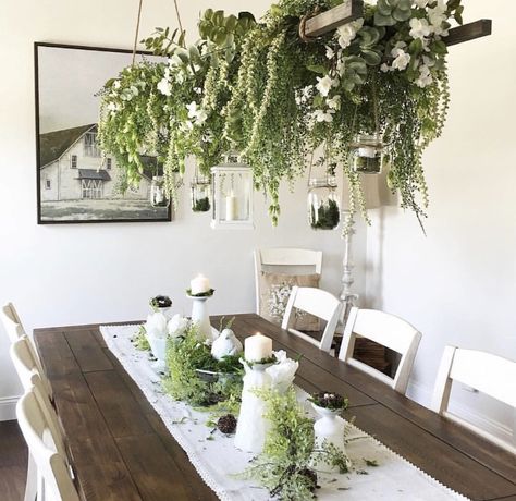 I love the farmhouse style of this dining room, but I love the abundance of plants even more! The hanging plants are definitely a staple piece for the room. #home #homedecor #homedecorideas #homedesign #farmhouse #farmhousedecor #farmhousestyle #farmhousediningchairs #farmhousediningroom #diningroom #diningroomideas #diningroomdecorating #diningroomdecor #inspiration Plant Dining Room, Chandelier With Flowers, Sunroom Dining Room, Sunroom Dining, Sunroom Decorating, Hanging Plants Indoor, Home Dining Room, Diy Chandelier, Room Display