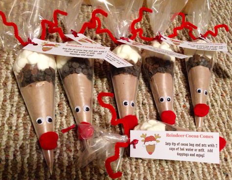 Made these for niece & nephews! Reindeer hot chocolate. Add 2 packages hot chocolate in 1 Whitman piping bag. Cut down to about an inch above cocoa, twist, & tape. Place it in another piping bag, whatever you want for toppings: Chocolate chips or chunks, peppermint pieces, and of course marshmallows. Twist & tape when done. Wrap pipe cleaner around twice and secure with ribbon (attach printable as you're tying it). Bend to form antlers. Glue nose and eyes! Find printable below in comment. Reindeer Sweet Cones, Rudolf Hot Chocolate Cones, Class Gifts For Kids, Reindeer Hot Chocolate Cones Easy Diy, Reindeer Hot Chocolate Cones, Christmas Class Gifts For Kids, Christmas Class Gifts, Rain Deer Poop Christmas Treats, Popcorn Reindeer Bags