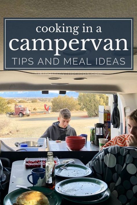 a boy cooking at the campervan kitchen while a girl sits in the campervan dining area Cooking In A Camper, Camper Cooking Ideas, Rv Dinners Ideas, Easy Camper Van Meals, Camper Van Food Ideas, Easy Vanlife Meals, Camper Van Cooking, Campervan Meal Ideas, Campervan Food Ideas