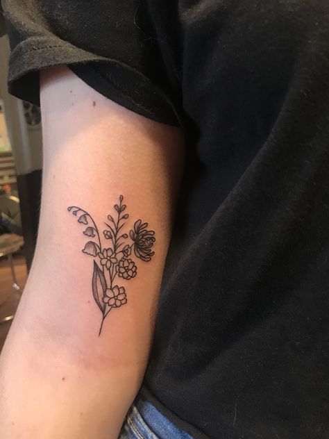 lily of the valley, larkspur and chrysanthemum arm tattoo. Tattoo Lily, Lily Of The Valley Tattoo, Larkspur Tattoo, Marigold Tattoo, Lily Valley, Valley Tattoo, Lotr Tattoo, Lady Bug Tattoo, Chrysanthemum Tattoo