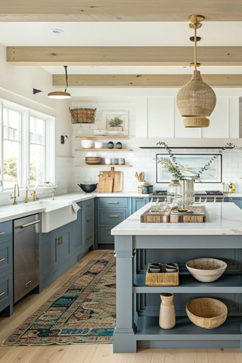 Step into this beautifully designed coastal farmhouse kitchen, where functionality meets the serene vibes of the seaside. The space features a generous island, perfect for gatherings and meal preps, paired with soothing color cabinets that evoke the tranquility of the ocean. Overhead, natural woven pendant lights cast a warm glow, complementing the open shelving that displays curated decor. The rustic runner adds a splash of color, seamlessly blending with the polished wooden accents. Woven Pendants Over Island, Kitchen Coastal Farmhouse, Kitchen Design Coastal Style, Kitchens With Natural Light, New England Coastal Homes Interior Design, Modern Rustic With Color, Beautiful Kitchen Colors, Light Green Grey Kitchen Cabinets, Pops Of Color In Kitchen