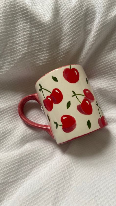 painted cherry mug on duvet Aesthetic Cup Painting, Painting On Cups Ideas, Cherries Pottery Painting, Cup Designs Painting, Cherry Mug Painting, Pottery Painting Fruit Design, Paint On Mugs Diy, Cherry Ceramic Mug, Paint Mugs Ideas