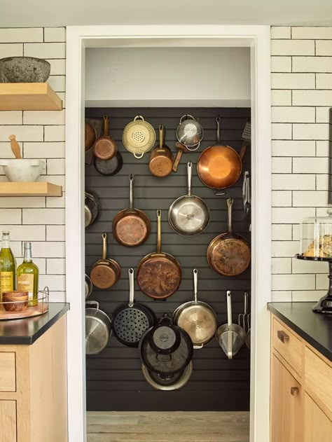 10 Ways to Organize Pots and Pans When Your Cabinet Space Is Limited Pans Storage Ideas, Organize Pots And Pans, Pot Rack Wall, Cookware Display, Kitchen Backslash, Pegboard Kitchen, Design Kitchen Cabinets, Abide With Me, Cookware Storage