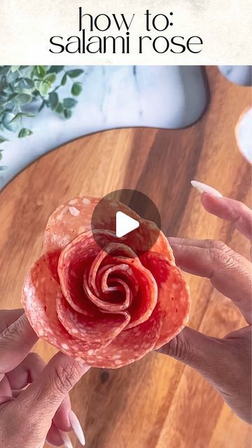 Kim Charon | Charcuterie & Things LLC on Instagram: "DIY: SALAMI ROSES 🌹 

Tools: 2oz condiment cup and 11 salami slices

Layer: Place 5 slices halfway over the first one around the cup. 

Create the bud: Fold 6 slices of salami in half with the rounded side up. Layer the folded slices on top of the other right to left. 

Roll: Start rolling from one end to the other, securing the base as you go.

Finish: Gently spread the “petals” to create a rose shape.

PRO TIP: Mix and match different types of salami for added texture and flavor. 🌟

SAVE and FOLLOW @charcuterie_n_things for more cheese and charcuterie food styling tips!

#charcuterie #foodstyling #cheese #grazingtable #partyplanning #fooddesign #longisland #fyp #charcuterieandthings #easyappetizers #quickandeasy #CheeseBoard #Charcut Charcuterie Board Ideas Salami Rose, Cheese Slices Charcuterie, How To Fold Meet For Charcuterie, Prosciutto Rose How To, Cheese Flowers Charcuterie, Rose Salami Charcuterie, Salami Flower Charcuterie, Folding Salami, Salami Roses How To