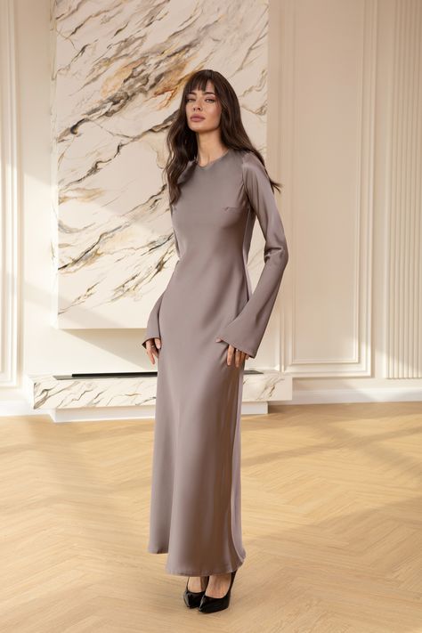 Experience the grandeur of royalty with the Alexa Mocco Satin Long Sleeve Maxi Dress. This exquisite gown features a luxurious satin finish and a majestic maxi length, complemented by elegant long sleeves that offer a truly regal presence at any formal affair.  #eveningdress #dress #dresses #stylish #dresslover #womenwear #maxidress #moccodress #longsleeve #satindress #weddingdress Elegant Silk Dresses, Satin Silk Dress, Satin Dresses Long Sleeve, Exquisite Gowns, Classic Outfit, Muslim Women Fashion, Satin Long Sleeve, Silk Dress Long, Muslim Fashion Outfits